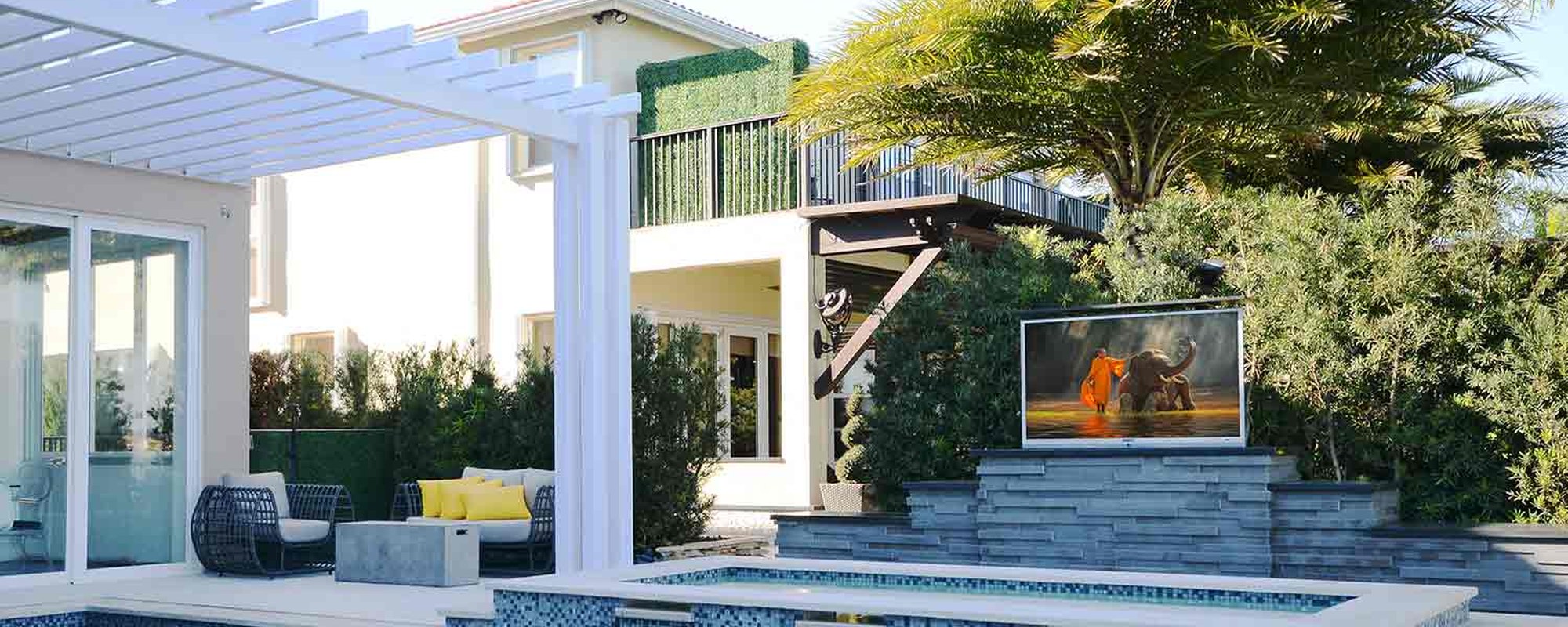 Nexus 21 TV lift rising from a poolside cabinet