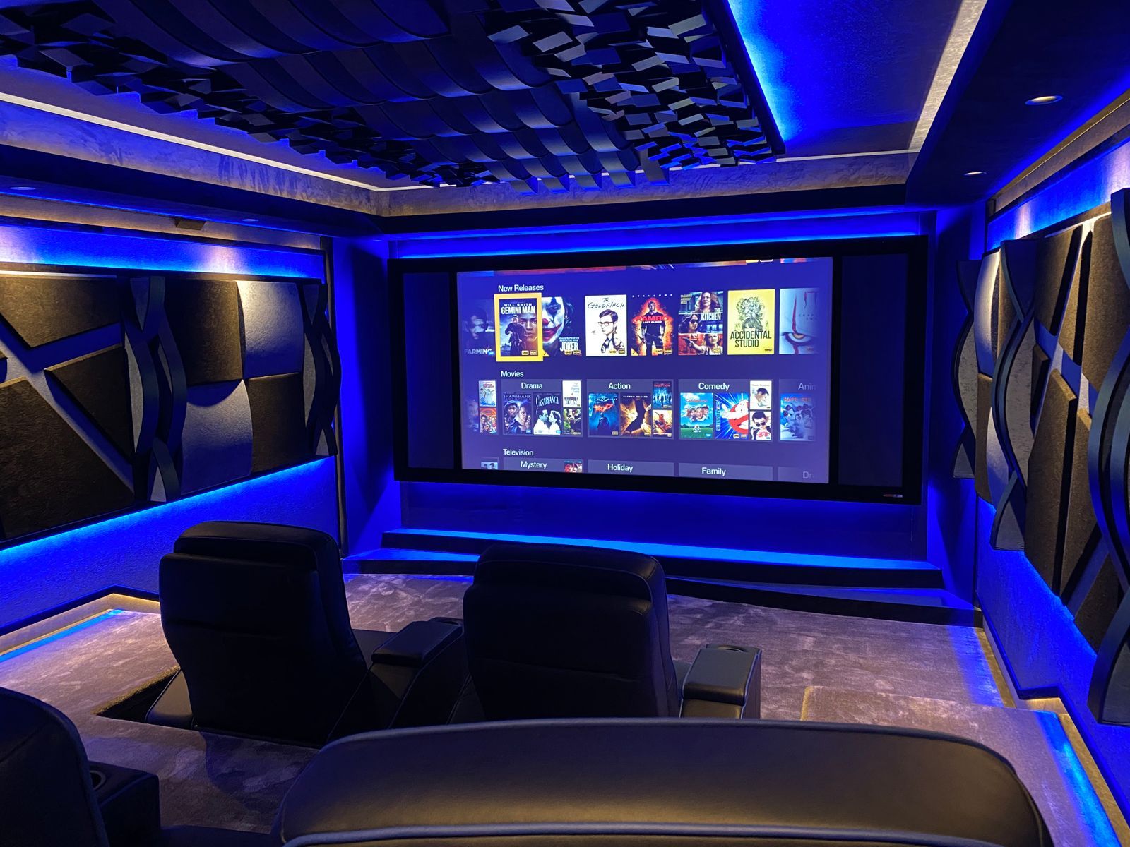 Home cinema with blue LED lighting and Vicoustic acoustic panels around a large projection screen