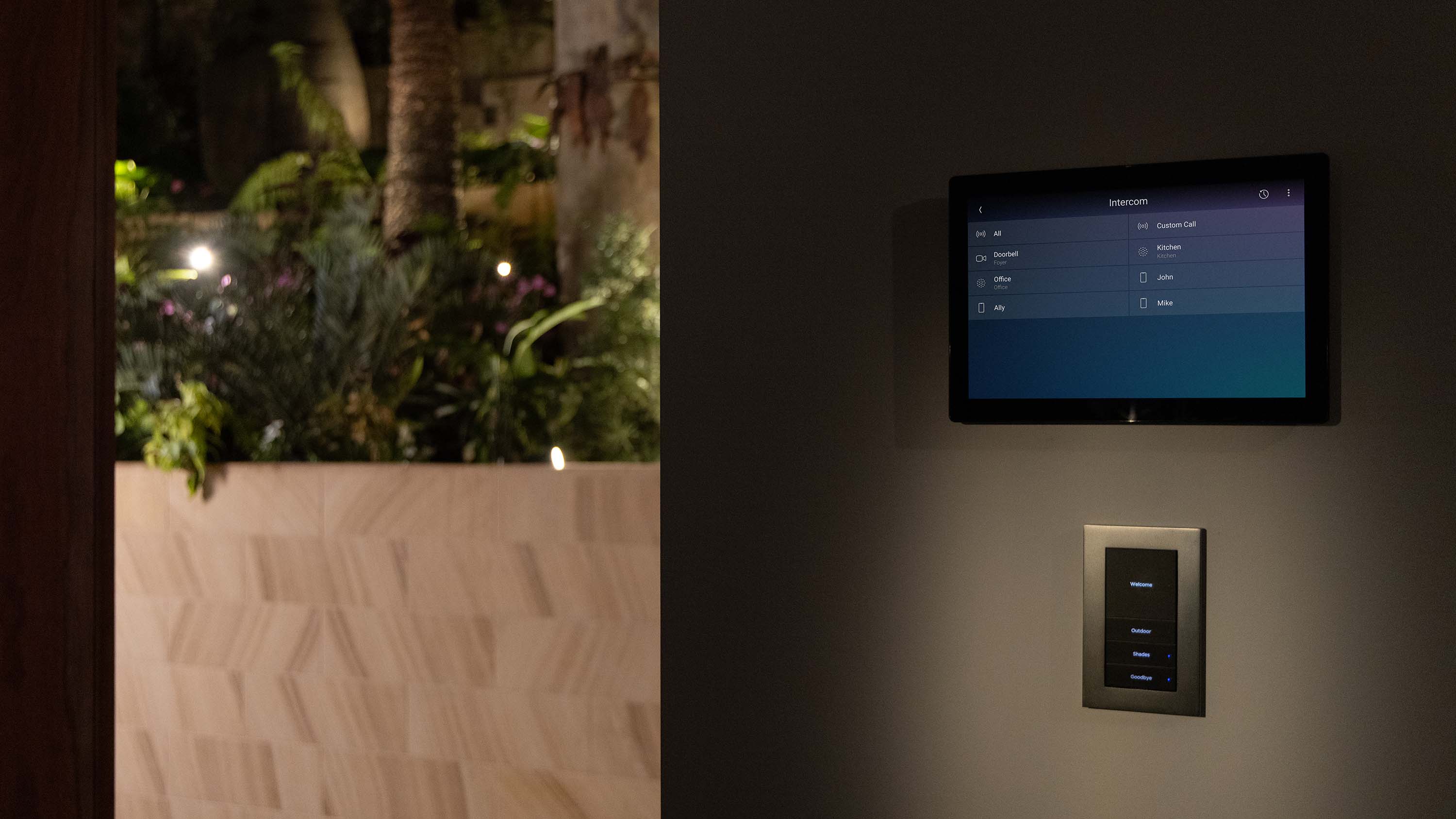 man holding touch panel with control4 interface on it