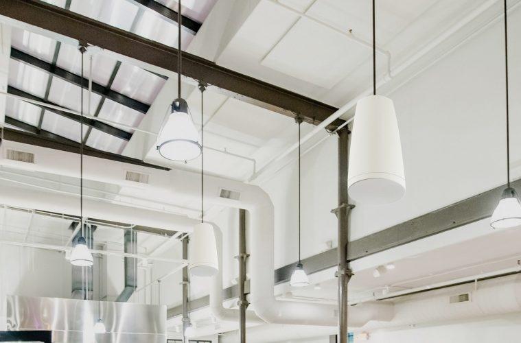 Industrial ceiling with hanging pendant speakers and lights