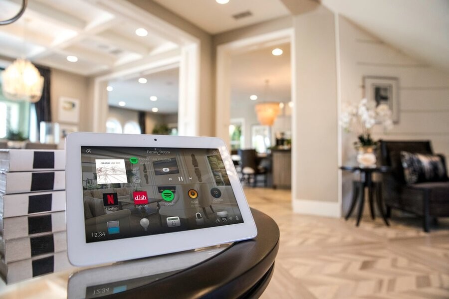 A Control4 touch screen interface in a living space.