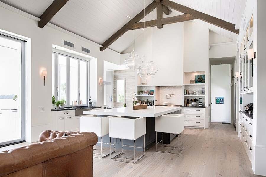 A luxury white kitchen illuminated by Lutron lighting